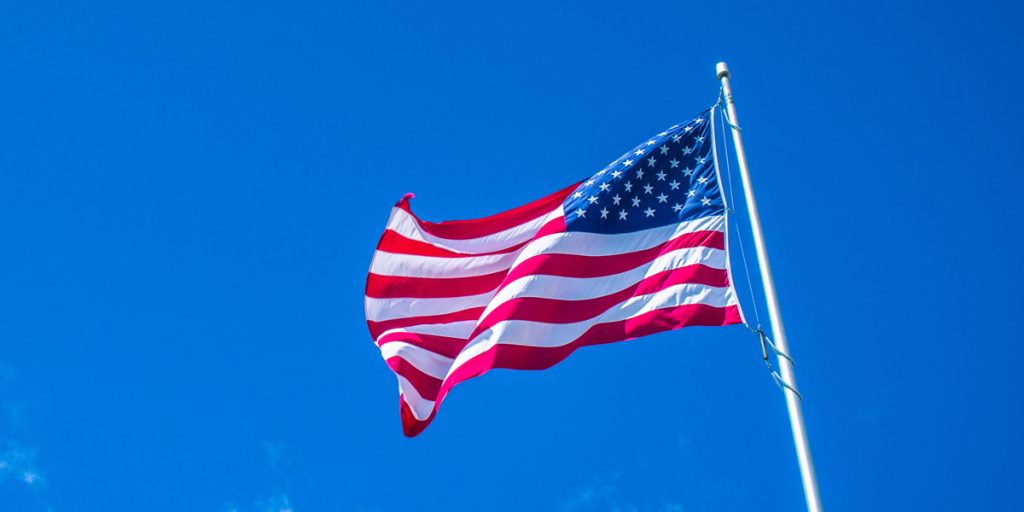 American flag waving in the wind on a flagpole