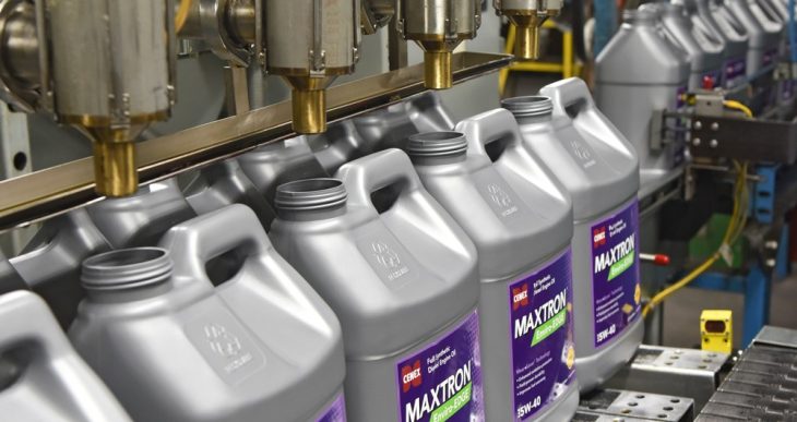 Cenex Maxtron product jugs being filled on a production line