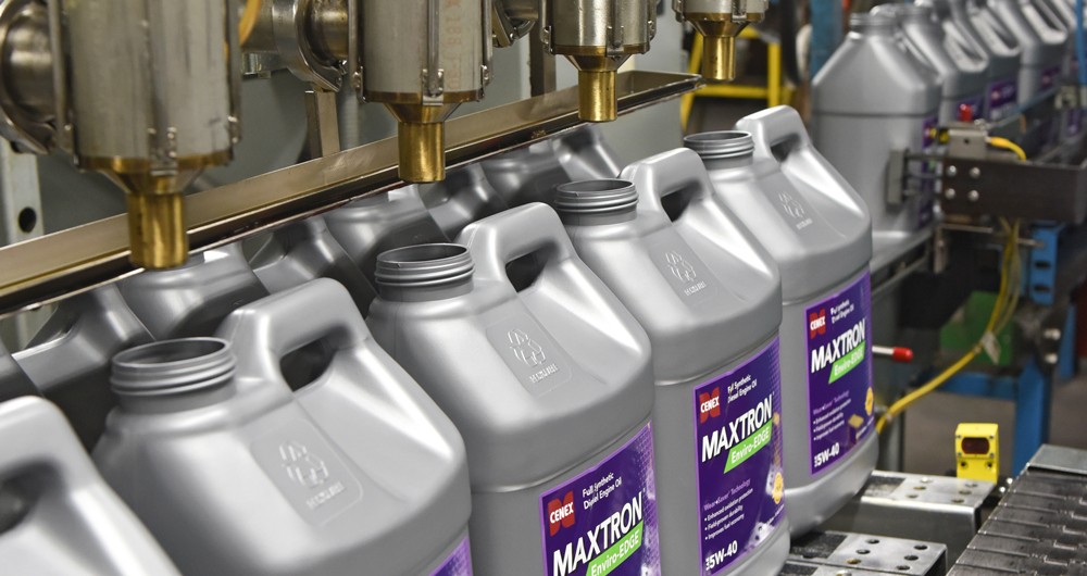 Cenex Maxtron product jugs being filled on a production line