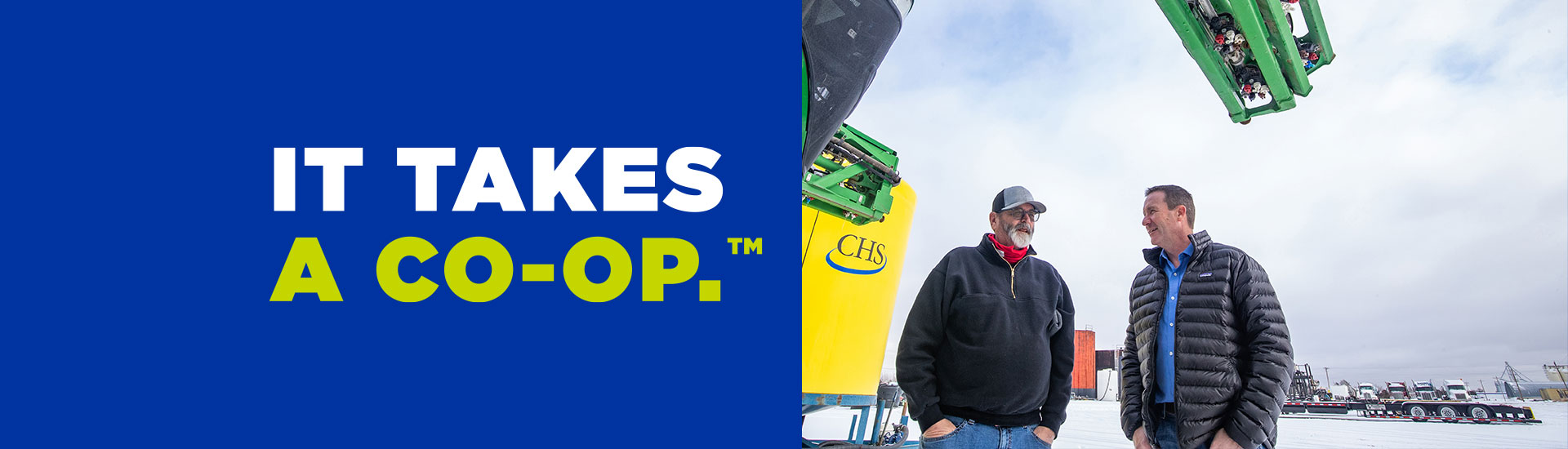 Two men with IT TAKES A CO-OP on the left.